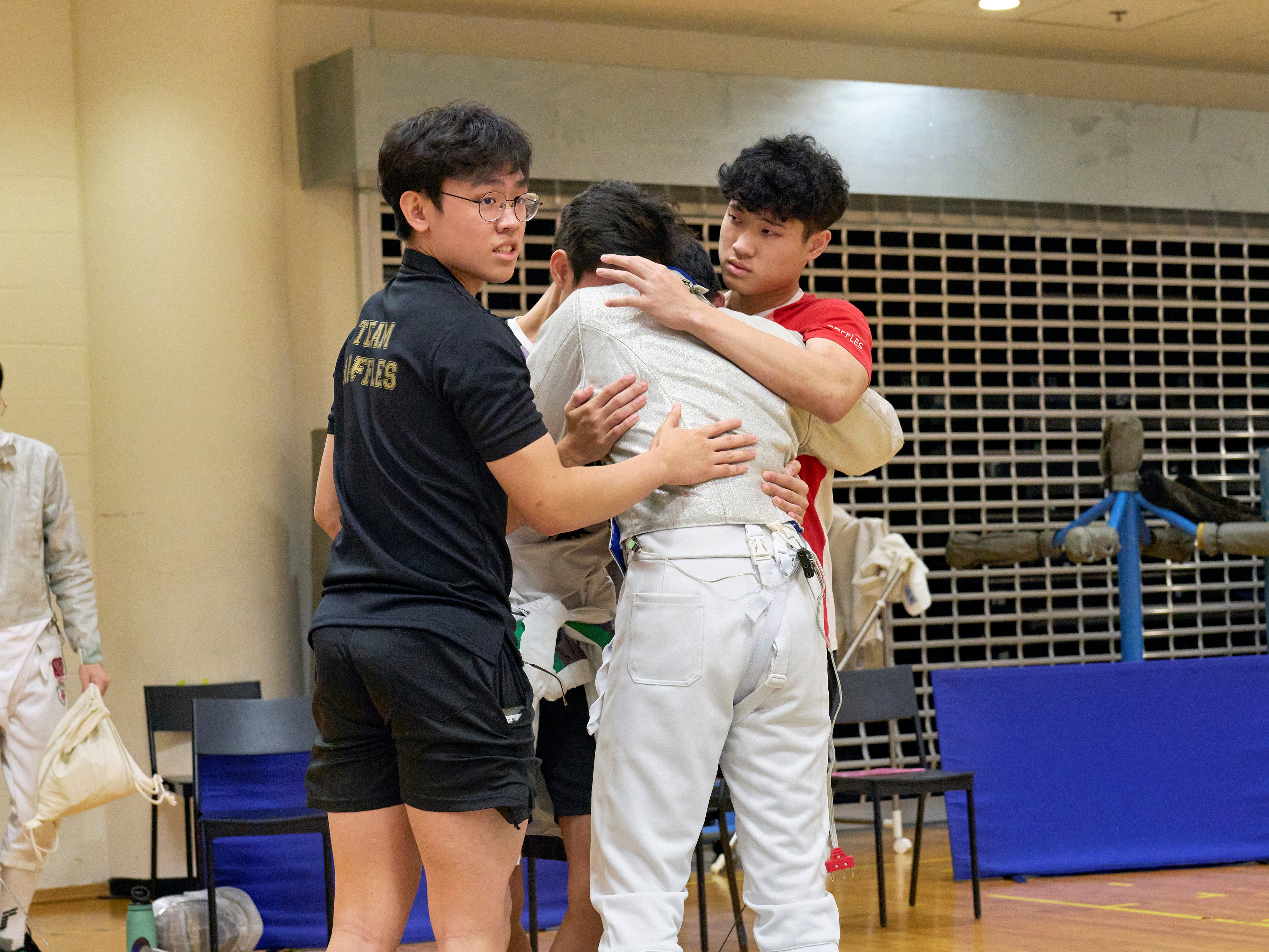 2023_04_20 Fencing Sabre A Div Boys Photo by Eric Koh, Friends consoling the fencer after his match DSC8164