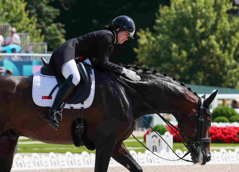 Caroline Chew gives her horse Zatchmo a congratulatory pat after they complete their individual dressage grand prix performance at the 2024 Paris Games.  Photo: Sport Singapore/Jeremy Lee