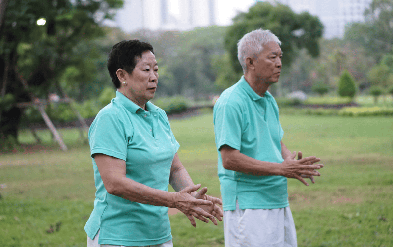 Elderly couple exercising under the sun