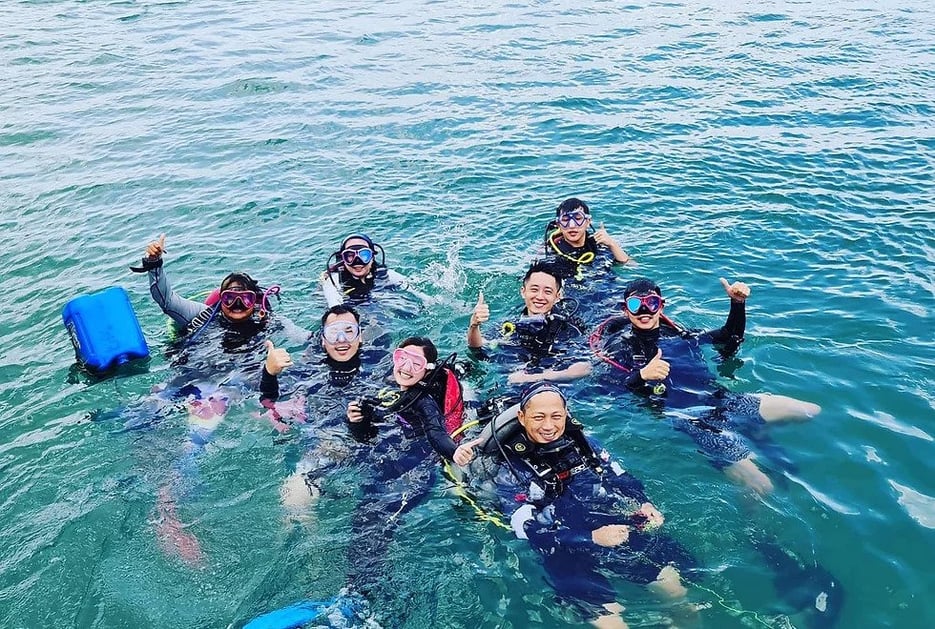 Group of friends scuba diving posing for a picture