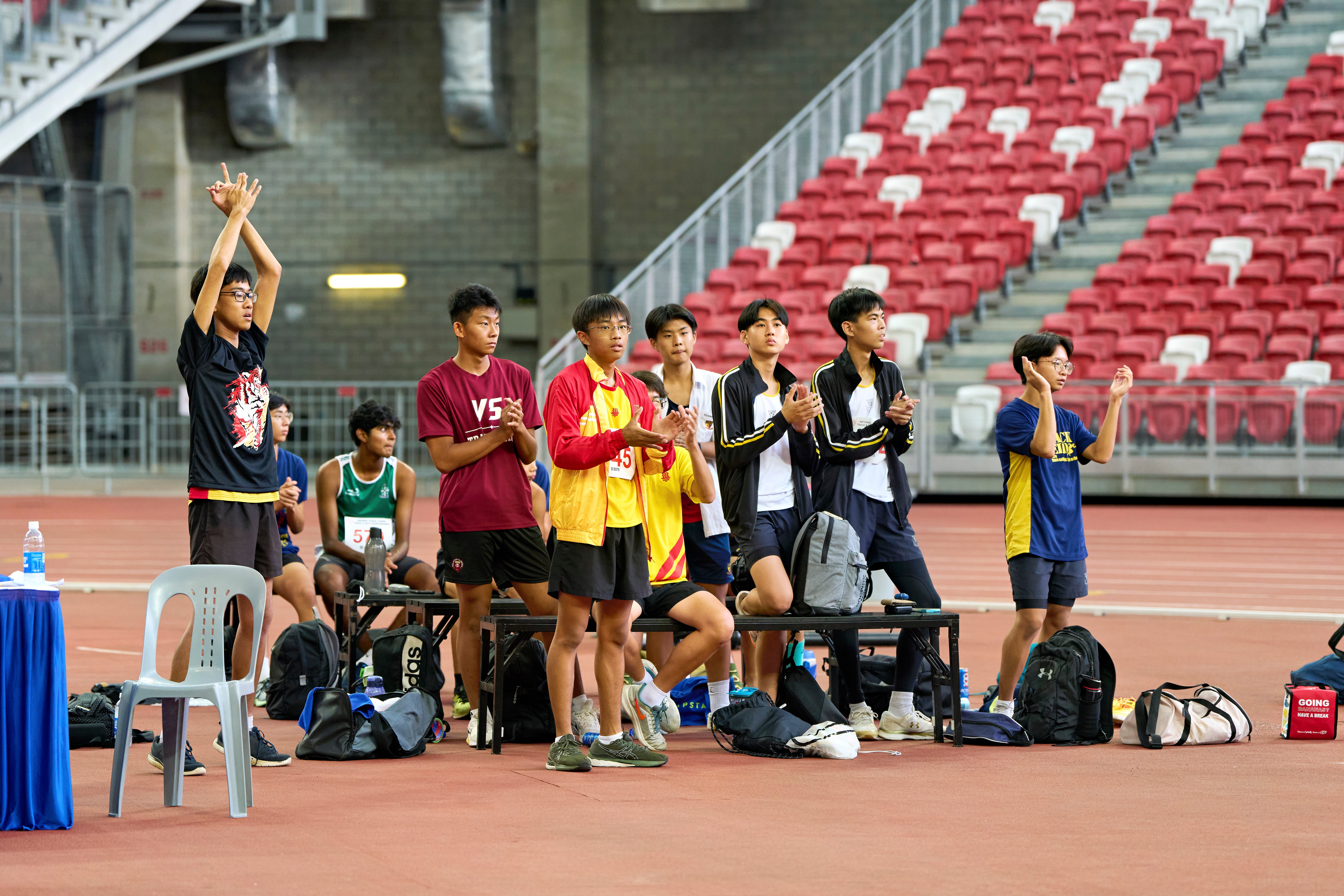 2023-04-28 NSG T&F Championships Photo by Eric Koh, Jumpers give encouragement to S Viresh Kumar(SPS) DSC07732