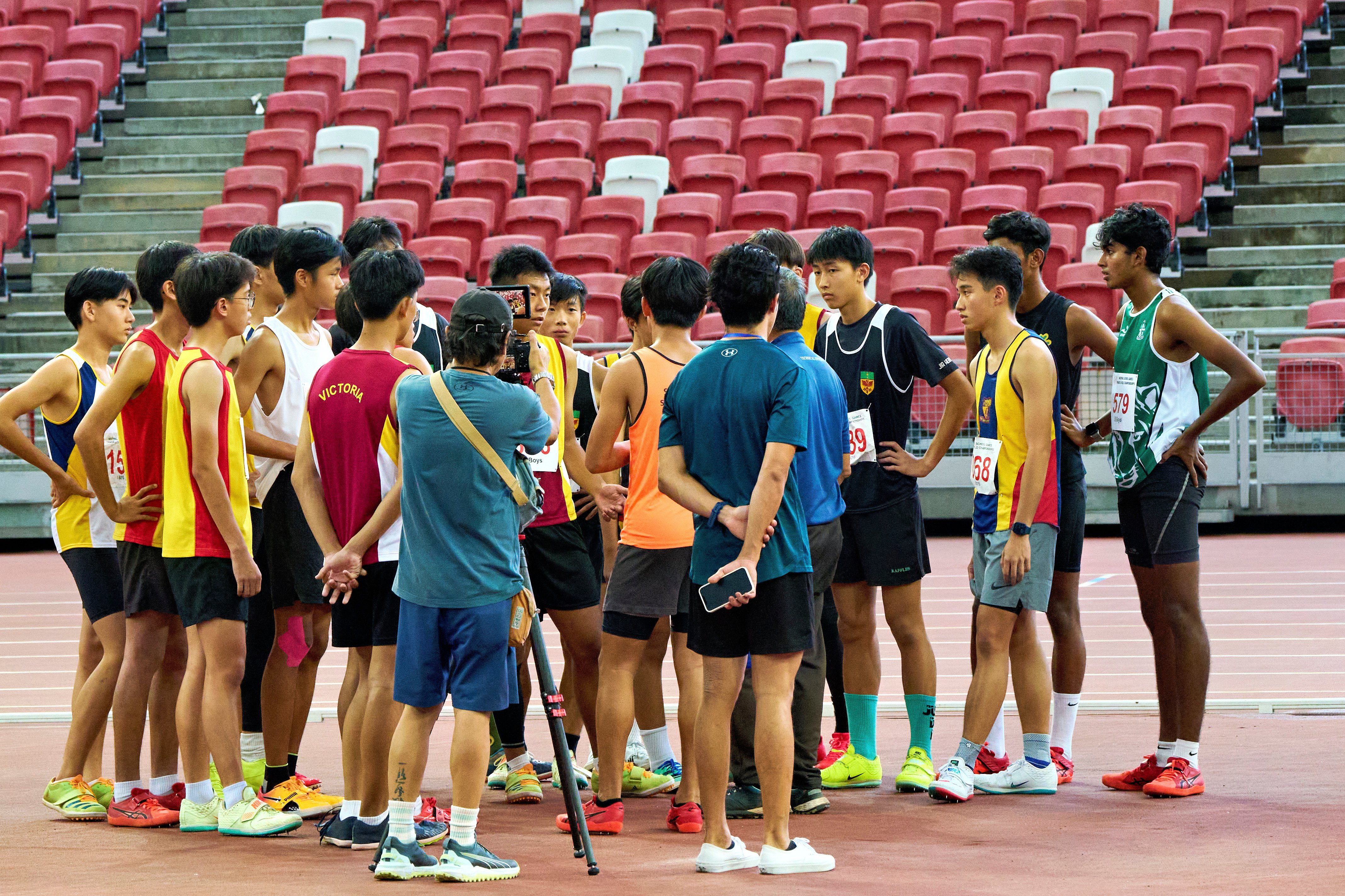2023-04-28 NSG T&F Championships Photo by Eric Koh, Technical Official briefs the finalists before the start of High Jump B Div Boys competition DSC06012