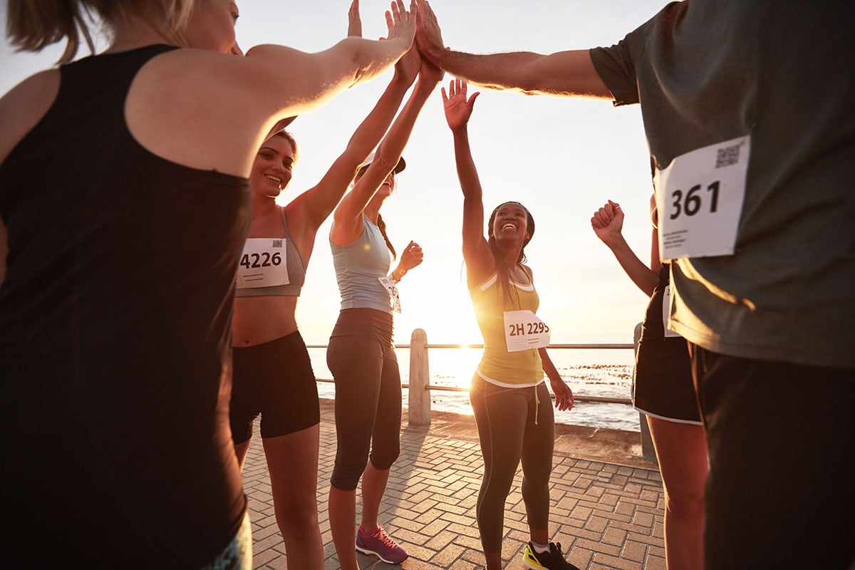 runners-high-fiving-each-other-after-a-race-2021-08-26-19-58-09-utc