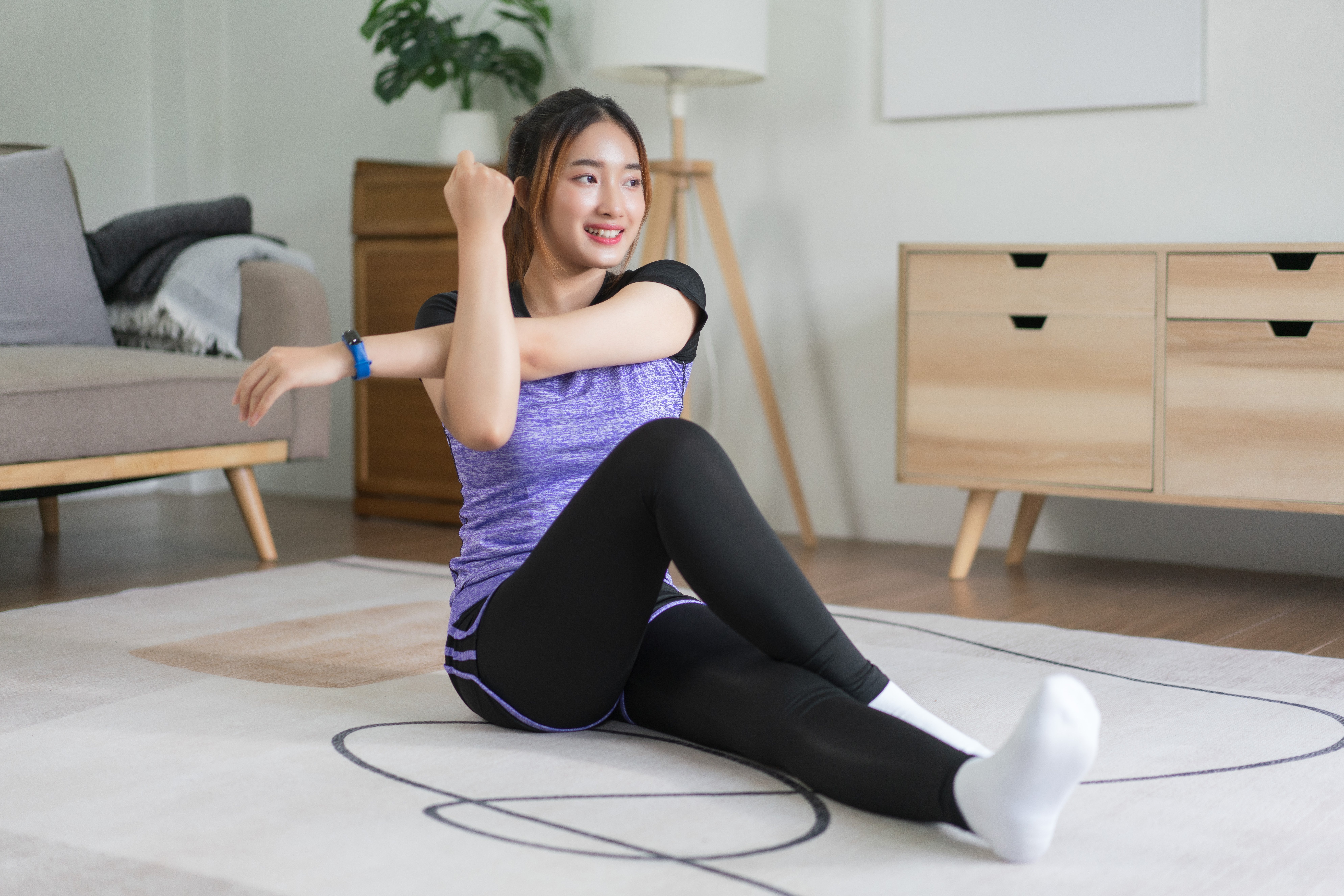 young-asian-woman-doing-exercise-to-stretching-arm-2023-08-29-08-21-57-utc
